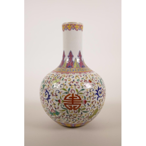 40 - A Chinese polychrome enamelled porcelain vase decorated with lotus flowers and the emblems of The Ei... 