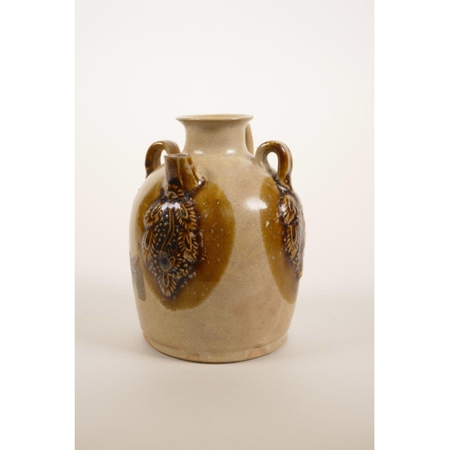 45 - A small Chinese brown glazed wine pourer with raised glazed vine decoration, 4½