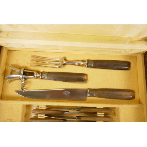 49 - A canteen of horn handled cutlery to include dinner and dessert knives, salad servers and a carving ... 