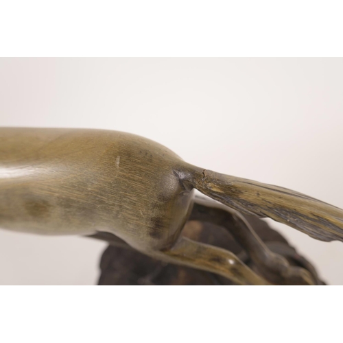 347 - An early C20th carved horn (possibly Rhino) car mascot in the form of a leaping horse, with brass mo... 