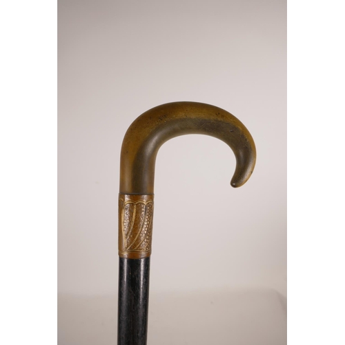 349 - A horn handled and ebonised wood walking stick with a gilt copper mount, handle possibly rhino horn,... 