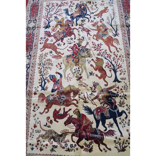 1135 - A red and ivory ground Kashmir carpet, decorated with a traditional hunting scene