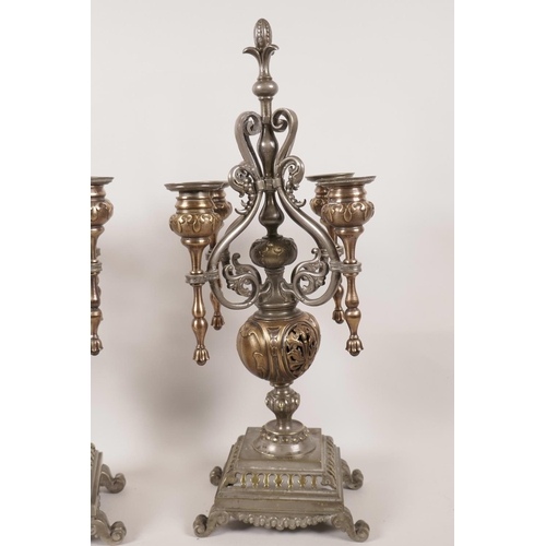 131 - A pair of French copper, brass and spelter four light table candelabra, 17