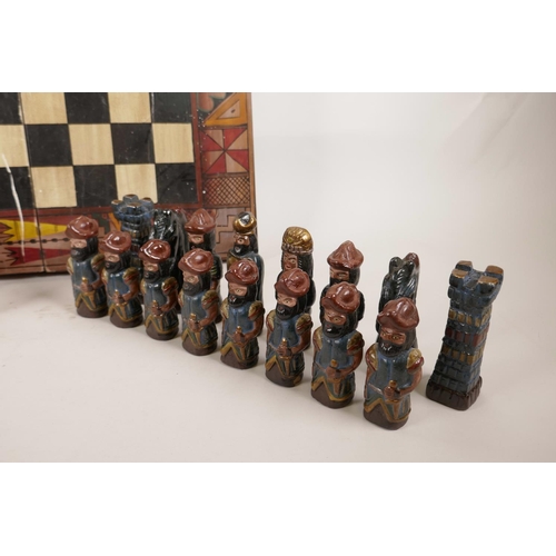 139 - An unusual pottery chess set consisting of Mayans and Persians, A/F, 18