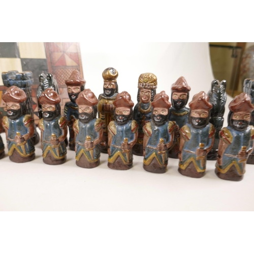 139 - An unusual pottery chess set consisting of Mayans and Persians, A/F, 18