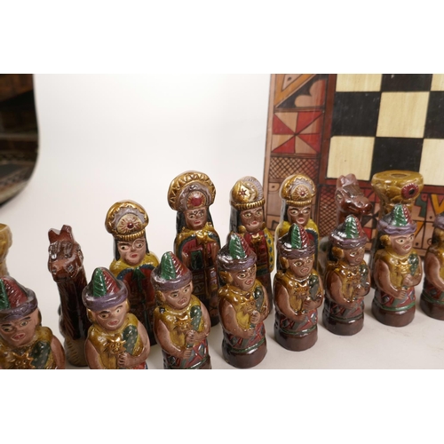 139 - An unusual pottery chess set consisting of Mayans and Persians, A/F, 18