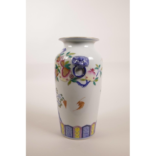 140 - A Chinese polychrome porcelain vase with two mask handles and enamelled pomegranate tree decoration,... 