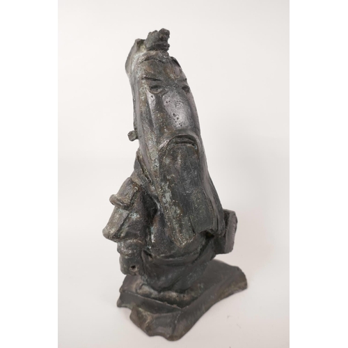 142 - A cast bronze figurine of an Oriental sage, the base marked No-099, 9½