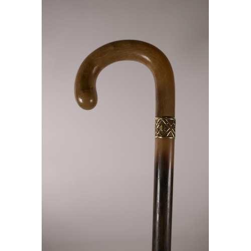 144 - A French late C19th early C20th rhinoceros horn walking stick with high carat gold mount, 36½