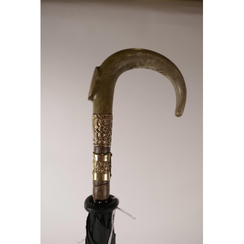 151 - A late C19th/early C20th rhino horn handled umbrella with a bamboo shaft and gilt metal mounts, 33½