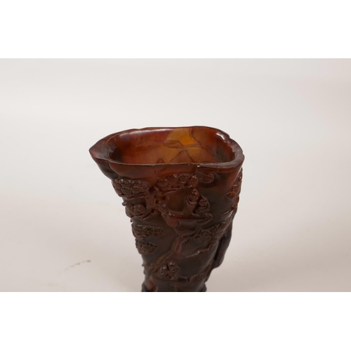 152 - A Chinese horn libation cup with carved decoration of a mountain landscape, character mark to base, ... 