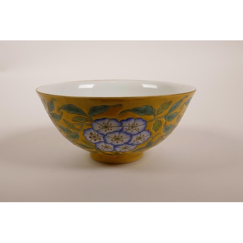 173 - A Chinese polychrome porcelain rice bowl with enamelled floral decoration on a yellow crackle ground... 