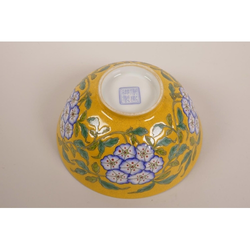 173 - A Chinese polychrome porcelain rice bowl with enamelled floral decoration on a yellow crackle ground... 