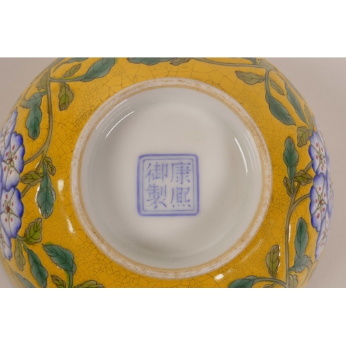 173 - A Chinese polychrome porcelain rice bowl with enamelled floral decoration on a yellow crackle ground... 