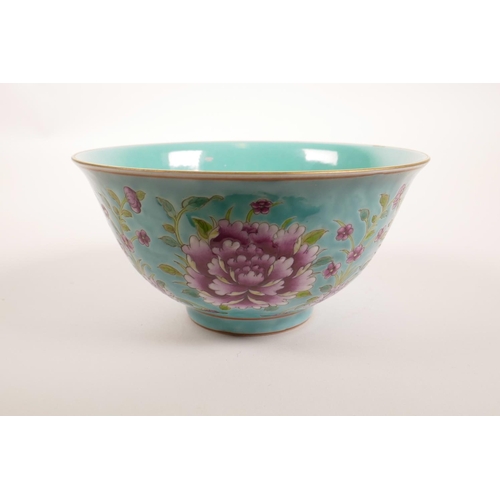 178 - A Chinese polychrome porcelain rice bowl decorated with bright flowers on a blue ground, seal mark t... 