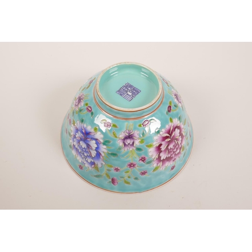 178 - A Chinese polychrome porcelain rice bowl decorated with bright flowers on a blue ground, seal mark t... 