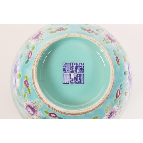 178 - A Chinese polychrome porcelain rice bowl decorated with bright flowers on a blue ground, seal mark t... 