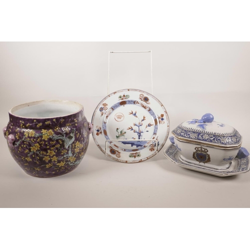 29 - A Chinese purple ground porcelain cache pot decorated with flowering trees in bright enamels, 6½