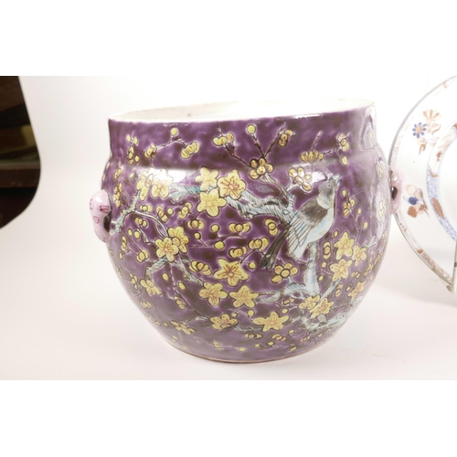 29 - A Chinese purple ground porcelain cache pot decorated with flowering trees in bright enamels, 6½