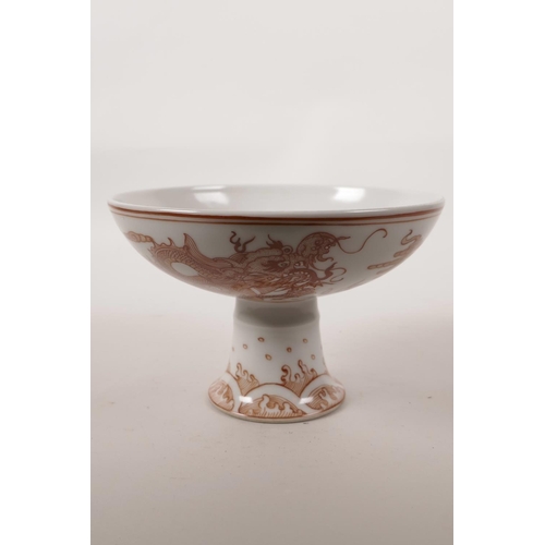 345 - A Chinese red and white porcelain stem bowl decorated with a dragon chasing the flaming pearl, seal ... 