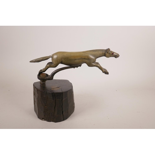 347 - An early C20th carved horn (possibly Rhino) car mascot in the form of a leaping horse, with brass mo... 