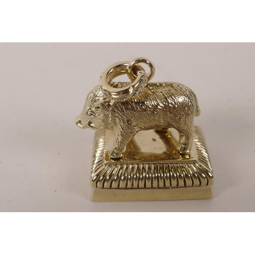 41 - A cast brass seal in the form of a wild boar standing on a plinth, the seal face bearing a coat of a... 