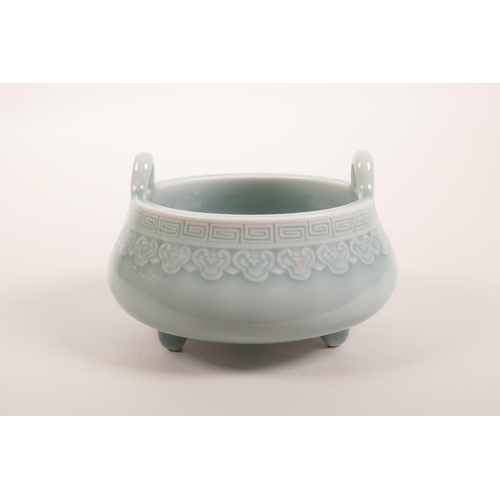 58 - A Chinese celadon glazed two handled pottery censer on tripod feet, seal mark to base, 5