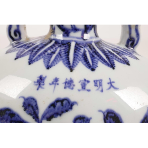 63 - A Chinese blue and white two handled moon flask decorated with branches bearing fruit, 6 character m... 