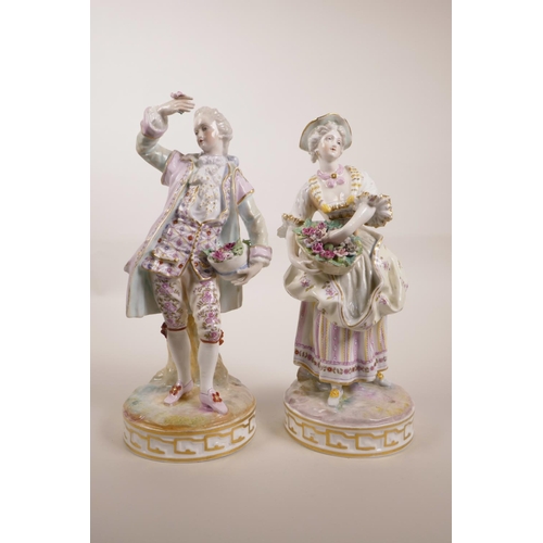 83 - A pair of Continental porcelain figures of flower pickers, marks to bases, minor losses, 10½