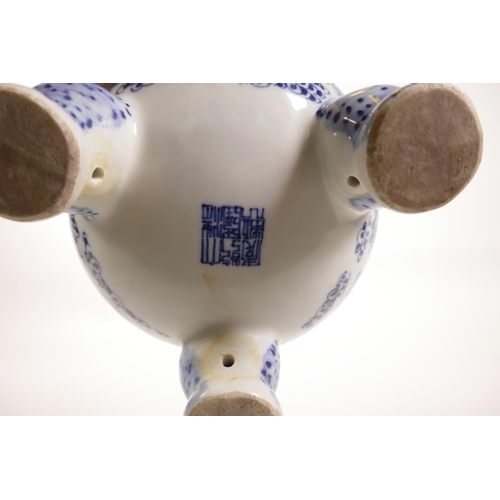 85 - A Chinese blue and white porcelain two handled censer on tripod feet, decorated with dragons chasing... 