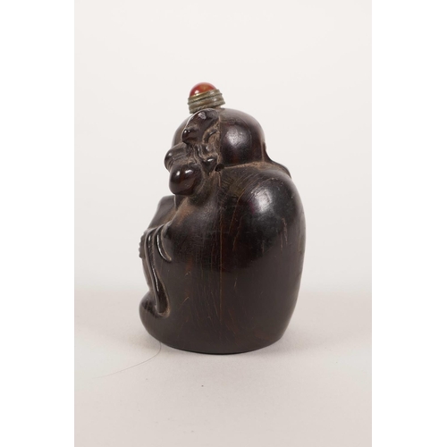 1 - A Chinese carved horn snuff bottle in the form of Shao Lao with a large peach, 2½