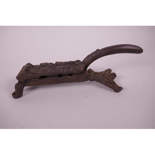 11 - A Kenrick cast iron nutcracker with leaf decoration, 10