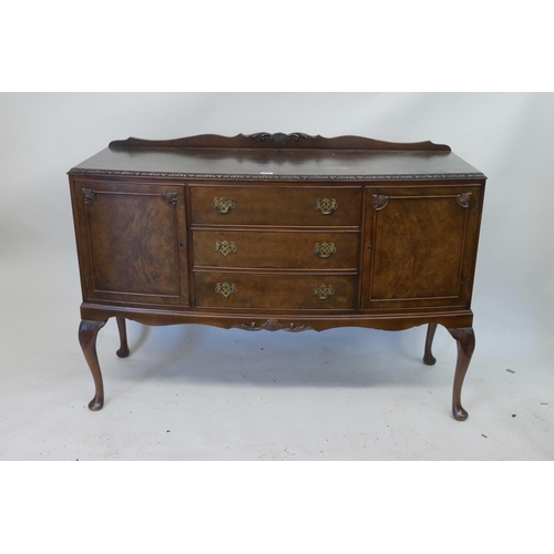 1130 - A 1920s walnut veneered walnut sideboard on carved cabriole legs, 54