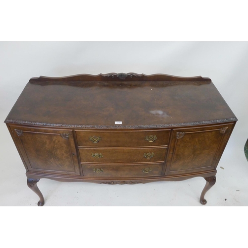 1130 - A 1920s walnut veneered walnut sideboard on carved cabriole legs, 54