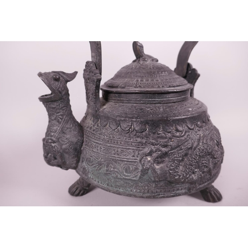 21 - A Chinese cast bronze ceremonial teapot with embossed dragon and fish decoration, the dragon spout e... 