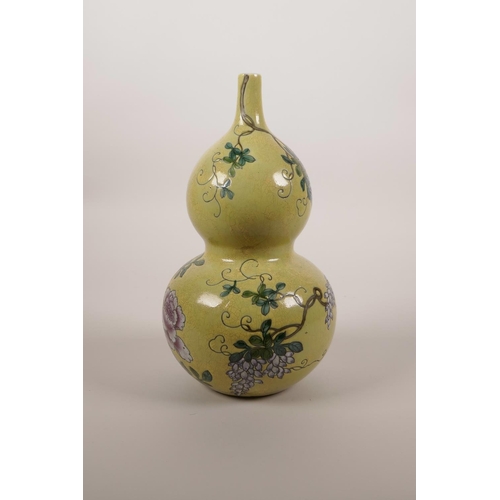 44 - A Chinese yellow ground double gourd porcelain vase with enamel decoration of a bird amongst vines a... 