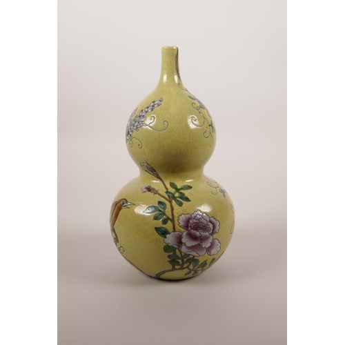 44 - A Chinese yellow ground double gourd porcelain vase with enamel decoration of a bird amongst vines a... 