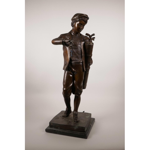 61 - A patinated bronze lamp in the form of a golfer, 22