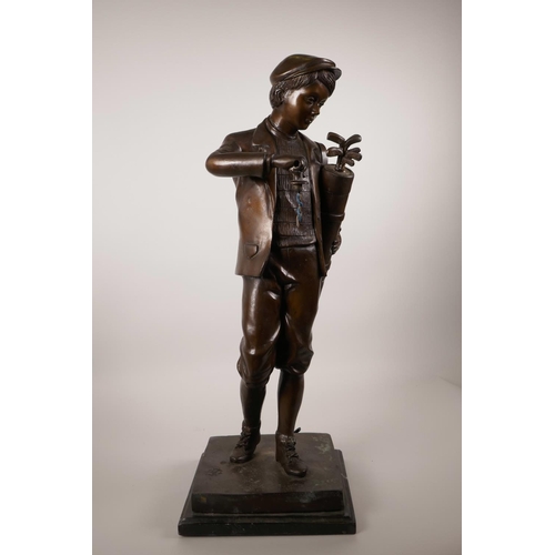 61 - A patinated bronze lamp in the form of a golfer, 22