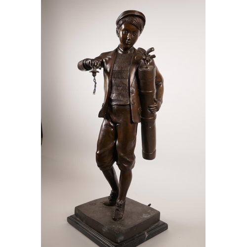 61 - A patinated bronze lamp in the form of a golfer, 22