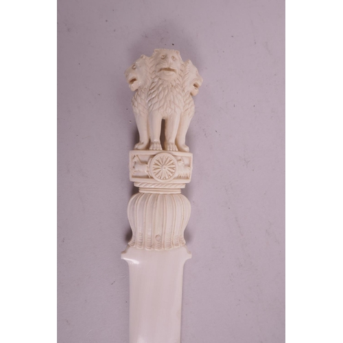 9 - A late C19th/early C20th ivory letter opener, with carved handle in the form of three lions, 12