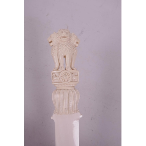 9 - A late C19th/early C20th ivory letter opener, with carved handle in the form of three lions, 12