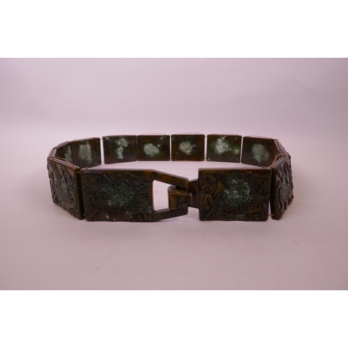 32 - A Chinese mottled hardstone belt with carved decoration of a monkey riding a horse, 39