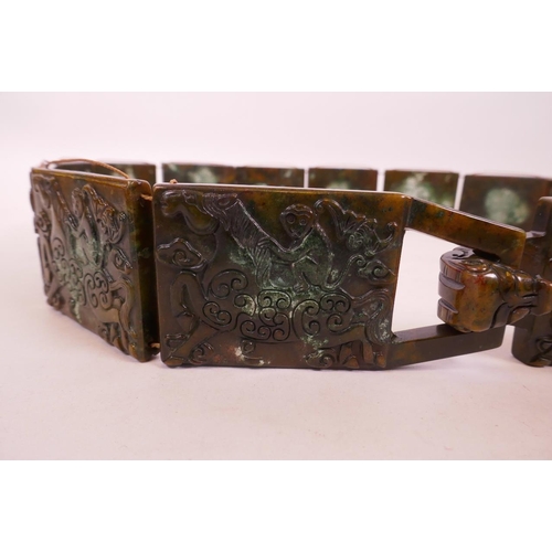 32 - A Chinese mottled hardstone belt with carved decoration of a monkey riding a horse, 39