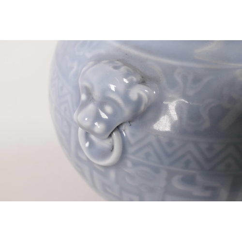 11 - A Chinese powder blue glazed vase with two mask handles and archaic style decoration, seal mark to b... 