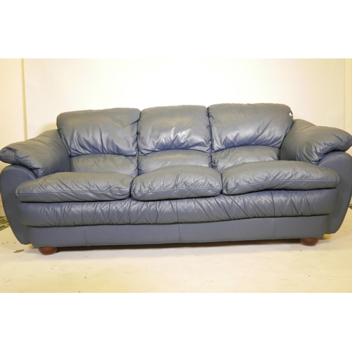 1108 - A blue leather three seater sofa, 84