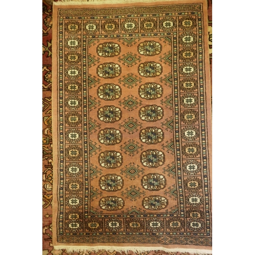 1114 - A salmon ground Bokhara pattern Eastern rug, 49