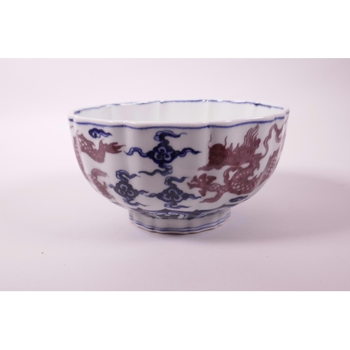 23 - A Chinese blue and white porcelain bowl with lobed rim and red dragon decoration, 6 character mark t... 