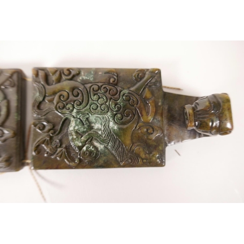 32 - A Chinese mottled hardstone belt with carved decoration of a monkey riding a horse, 39