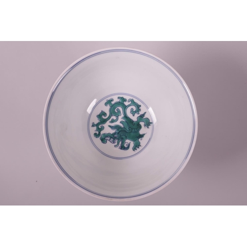 33 - A Chinese blue and white porcelain stem bowl with green enamelled dragon decoration, 6 character mar... 